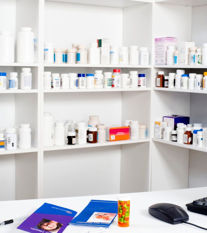 a shelf with medicine bottles and a computer mouse